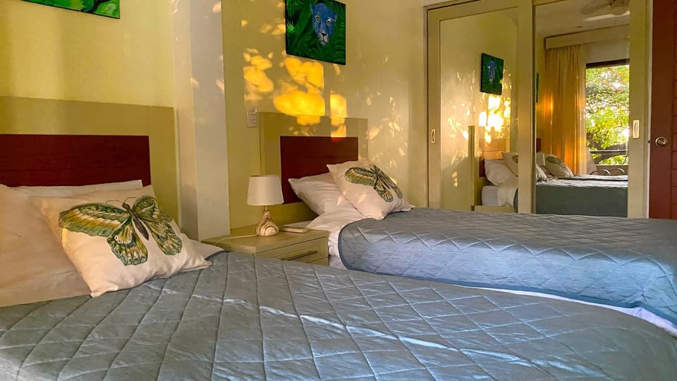 The second bedroom features one single bed and one double bed.
