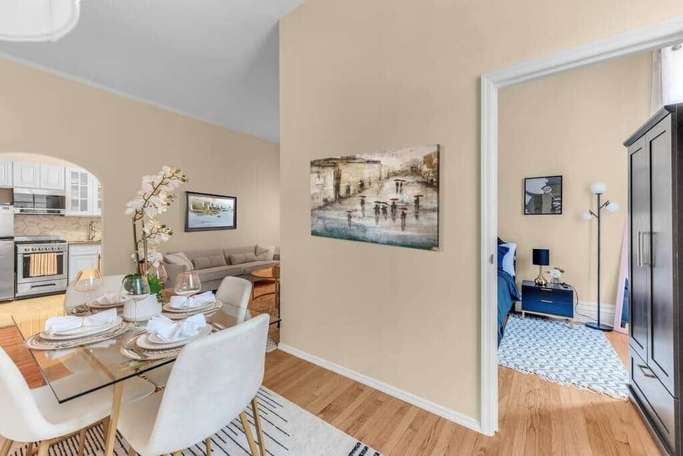 Open-plan dining area connecting bedroom & kitchen spaces