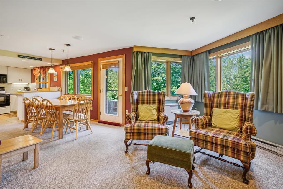 Two oversized armchairs beside large windows create the perfect spot for morning coffee or evening reading.