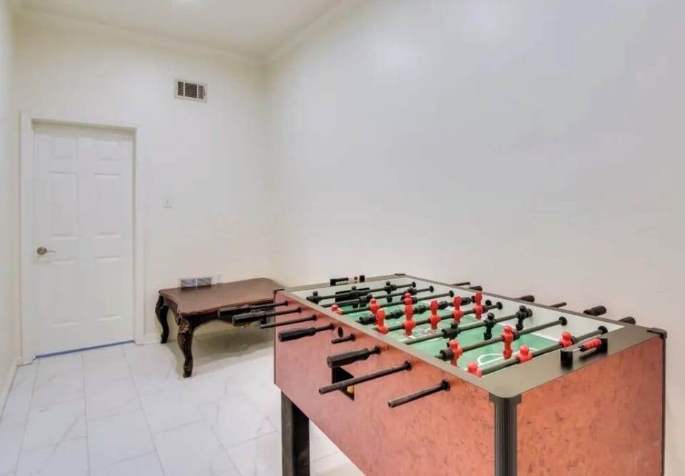 Foosball table by the bar and pool table.