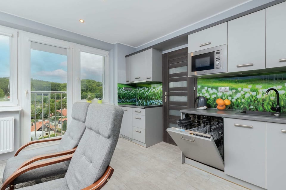 Kitchenette with plenty of kitchen utensils and dishes. 