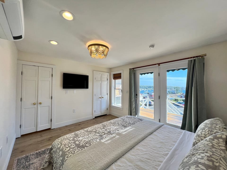 Wake up to sweeping harbor views from your king bed, then step onto your private balcony to soak in the Maine coast. This second-floor retreat offers comfort, charm, and coastal elegance in the heart of Boothbay Harbor.