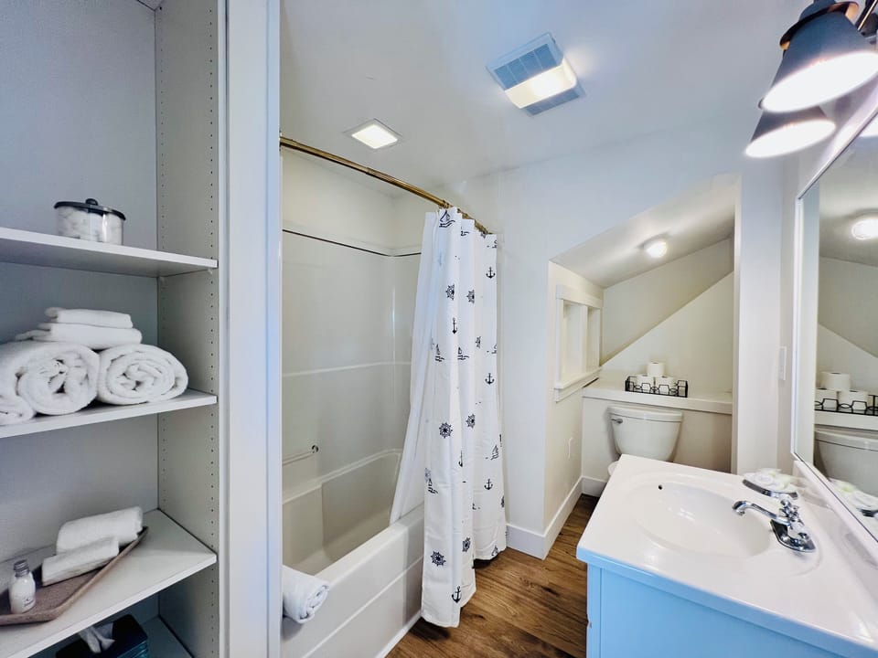 Enjoy a bright and well-appointed private bathroom featuring a full tub/shower, plush towels, and thoughtful amenities—perfect for unwinding after your Boothbay Harbor adventures.