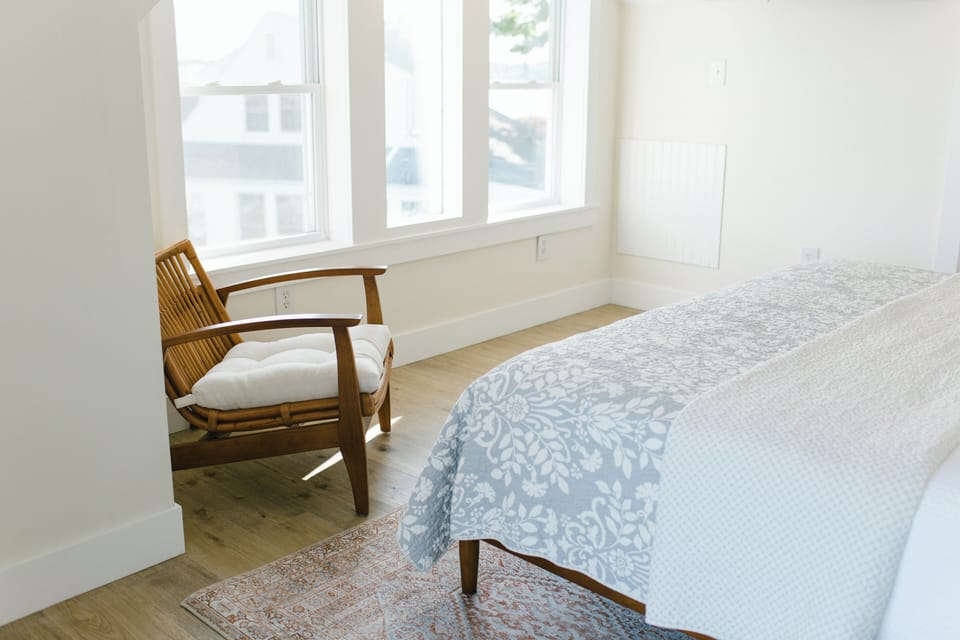 Room 7 offers a quiet nook with natural light, cozy seating, and peaceful views—perfect for reading, relaxing, or simply enjoying the calm of Boothbay Harbor.