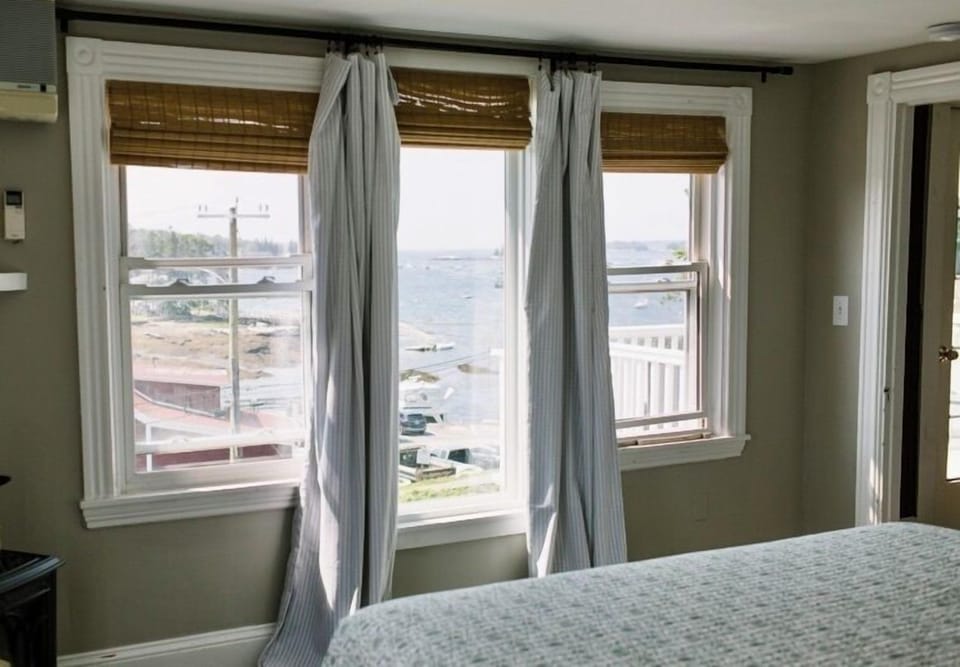 Wake up to panoramic Boothbay Harbor views through large windows in Room 15. Enjoy natural light, ocean breezes, and a front-row seat to the coastal charm of Maine.