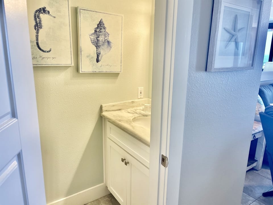 You enter the half bathroom from the entry hallway!