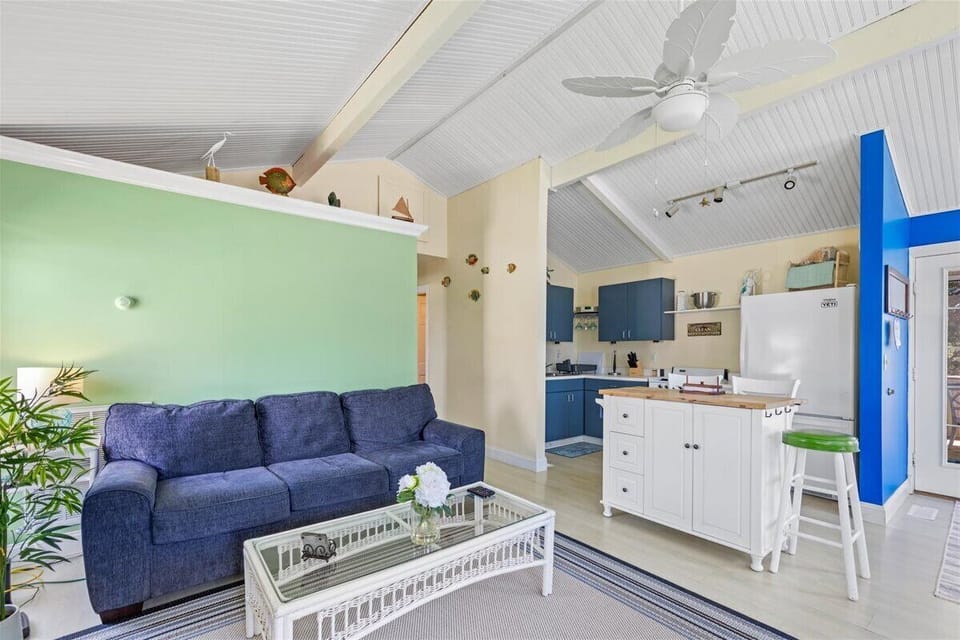 Living Area opens to Well-Stocked Kitchen.