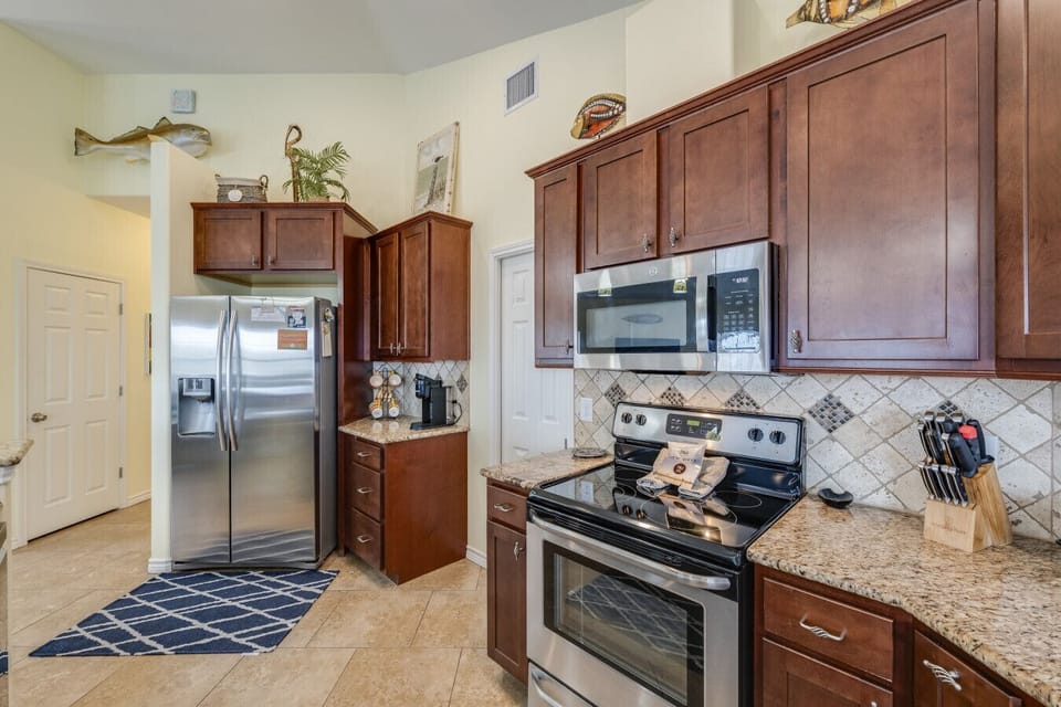Well-appointed kitchen with modern appliances, generous counter space, and a warm, inviting feel.