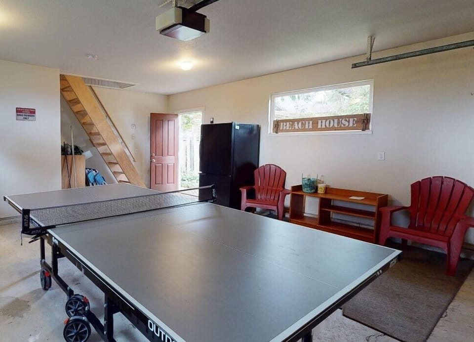 Garage with ping pong table and 1/2 bath. Available for guest use.