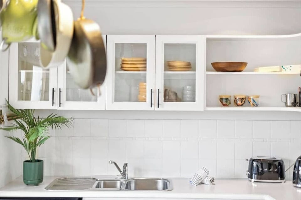 Cook with ease in our kitchen, equipped with a convenient sink, toaster, ample kitchen cabinets, and plates for your meals.