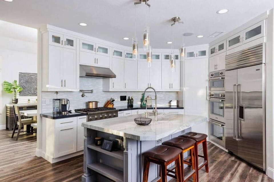 Imagine cooking in this fully remodeled Gourmet Chef's Delight Kitchen. Triple stack professional grade Thermador ovens, 6 burner stove, pot filler, and large island with extra large industrial style Farmhouse sink.  Perfect for the family cook, and 