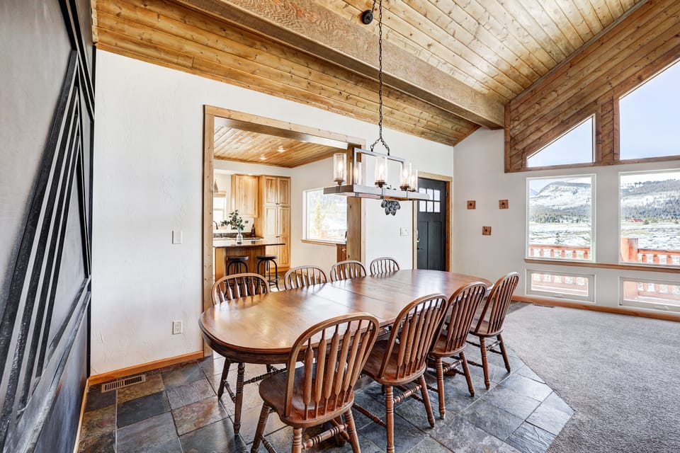 Open dining area with wood table and mountain-inspired design.