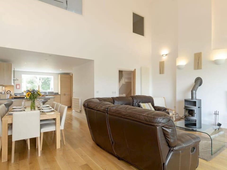 Large open plan sitting room, dining area and kitchen overlooking the lake