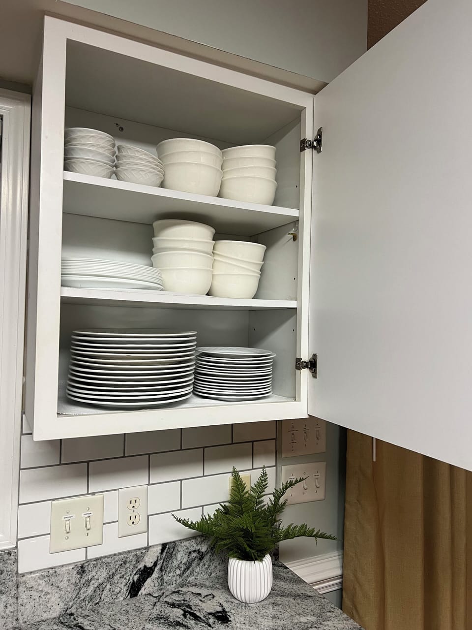 Kitchen cabinets full of dishes