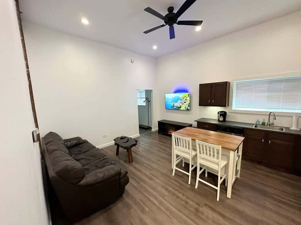 Step inside to the soften kitchen and living room, with the bedroom just off the living area. Head left and up two steps to access the bathroom and laundry area.