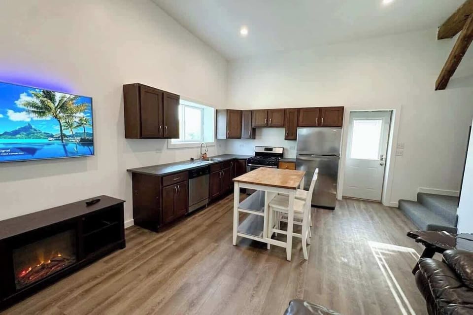 (MAIN LEVEL) Relax in the cozy living area with a 55" smart TV and an electric fireplace. The kitchen features stainless steel appliances, ready for your favorite meals for this fall.