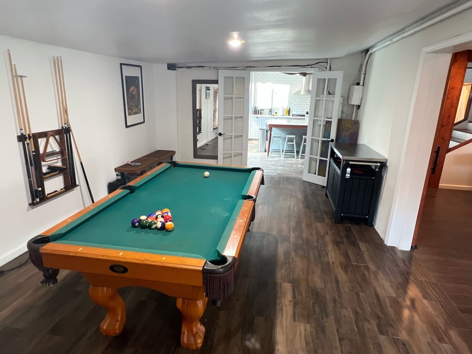 Play a game of pool in the downstairs side living room 
