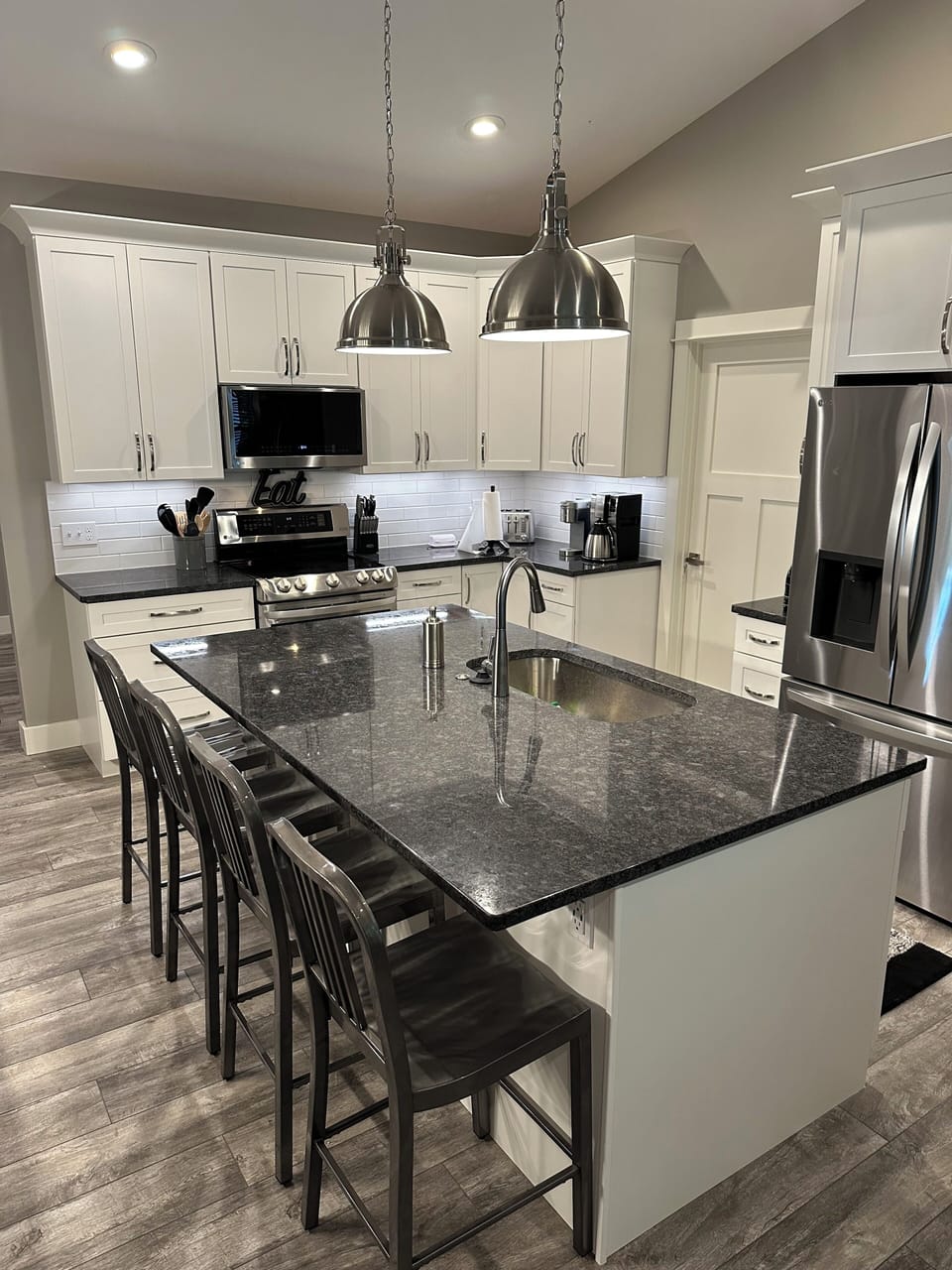 Kitchen with granite countertops, plenty of room for cooking and bar seating
