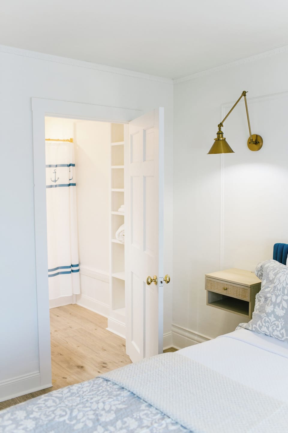 Room 2 features a private en-suite bath with nautical accents, built-in shelving, and coastal charm—adding comfort and convenience to your Boothbay Harbor stay at the Greenleaf Inn.