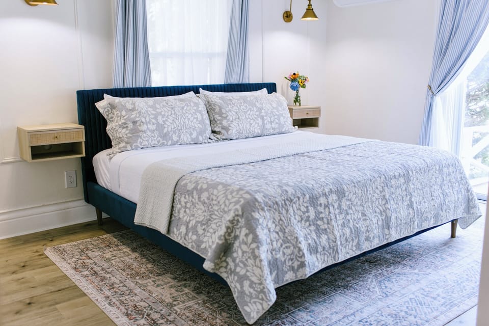 Unwind in Room 2 at Greenleaf Inn, featuring a plush king bed, soft natural light, coastal decor, and garden views. A peaceful Boothbay Harbor retreat with charm, comfort, and style.