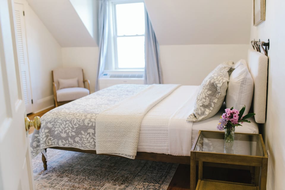 Charming and peaceful, Sarah's Room features a cozy queen bed, sloped ceilings, soft natural light, and classic coastal decor—perfect for a restful retreat in Boothbay Harbor, Maine.