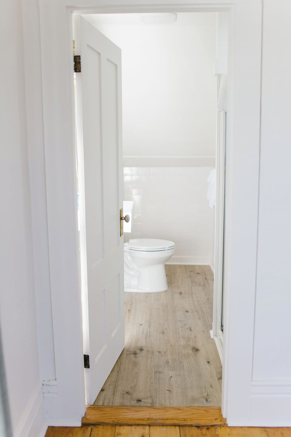Room 4 includes a bright, private ensuite bathroom with updated flooring, classic fixtures, and fresh white tile—perfect for a comfortable and convenient stay in Boothbay Harbor, Maine.