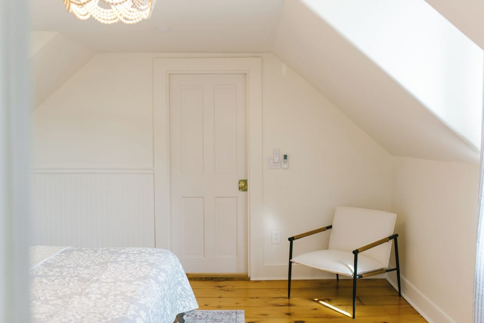 Room 5 at the Greenleaf Inn in Boothbay Harbor offers cozy elegance with a queen bed, charming angles, modern AC, and peaceful views. Perfect for a restful Maine getaway just steps from the harbor.