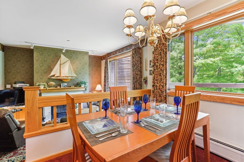 The dining space offers beautiful views through large windows, seating for six, and easy access to the kitchen and living room — perfect for sharing meals and conversation.