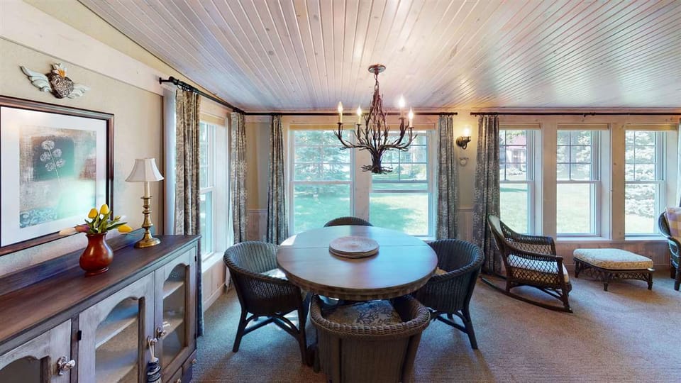 Dining area in large house- table has leaf and extra chairs. 