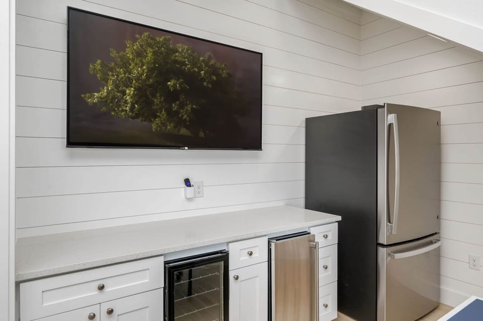 1st floor bar area with beverage center, ice maker, and full fridge