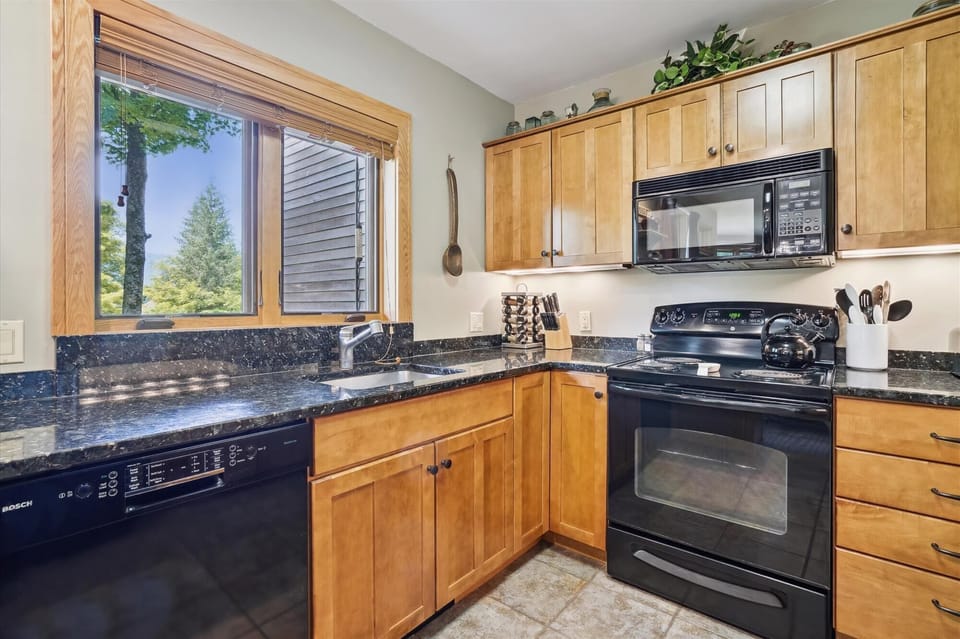 The heart of this home, the kitchen — with adjoining dining and living rooms — make it ideal for gatherings. Upgraded with plenty of counter space.