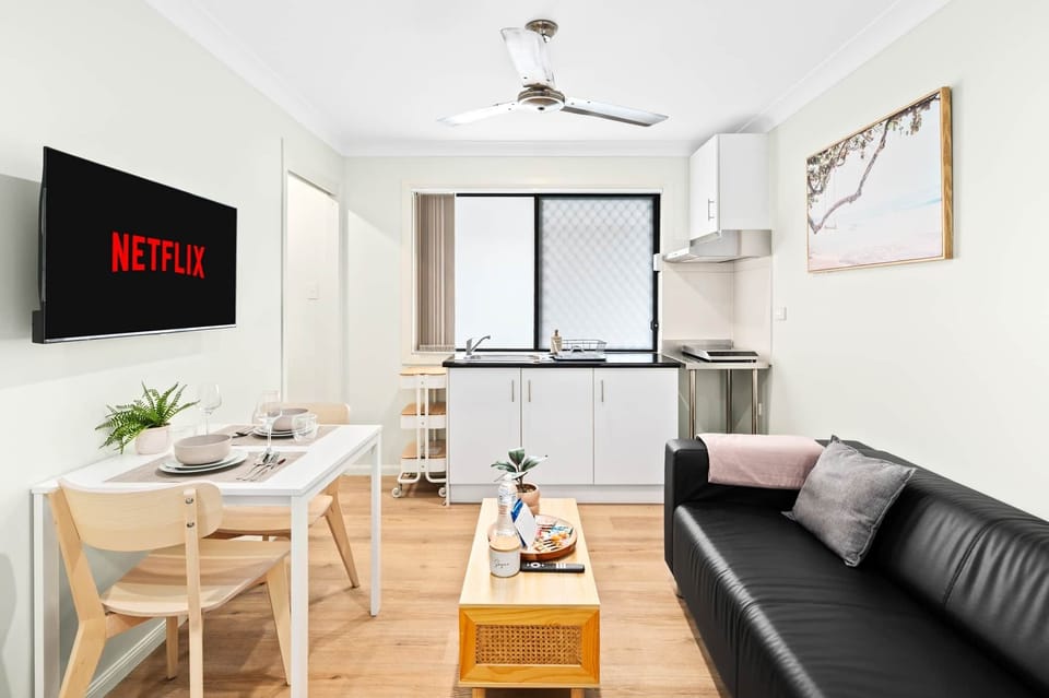 Living Area: Bright living space with comfortable seating and TV 