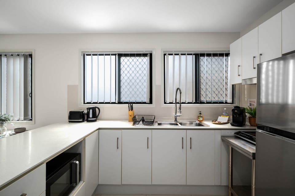 Kitchen: Sleek kitchen with ample storage, modern appliances 
