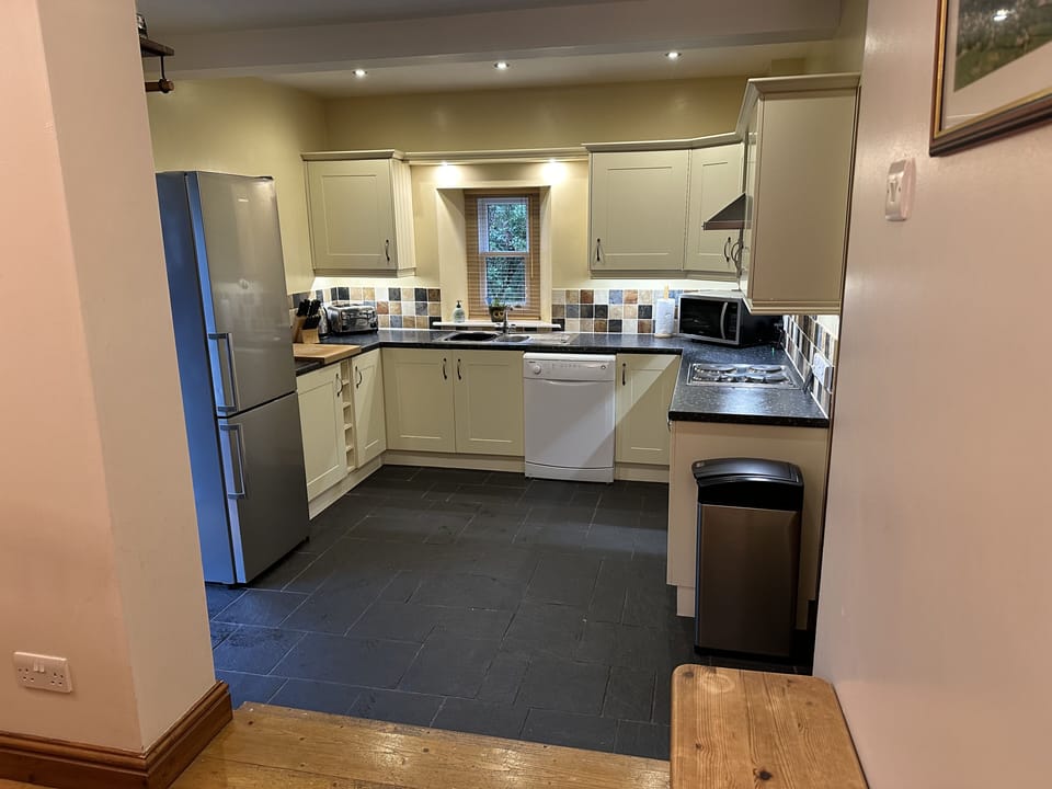 Modern fitted kitchen with stable door and separate utility room