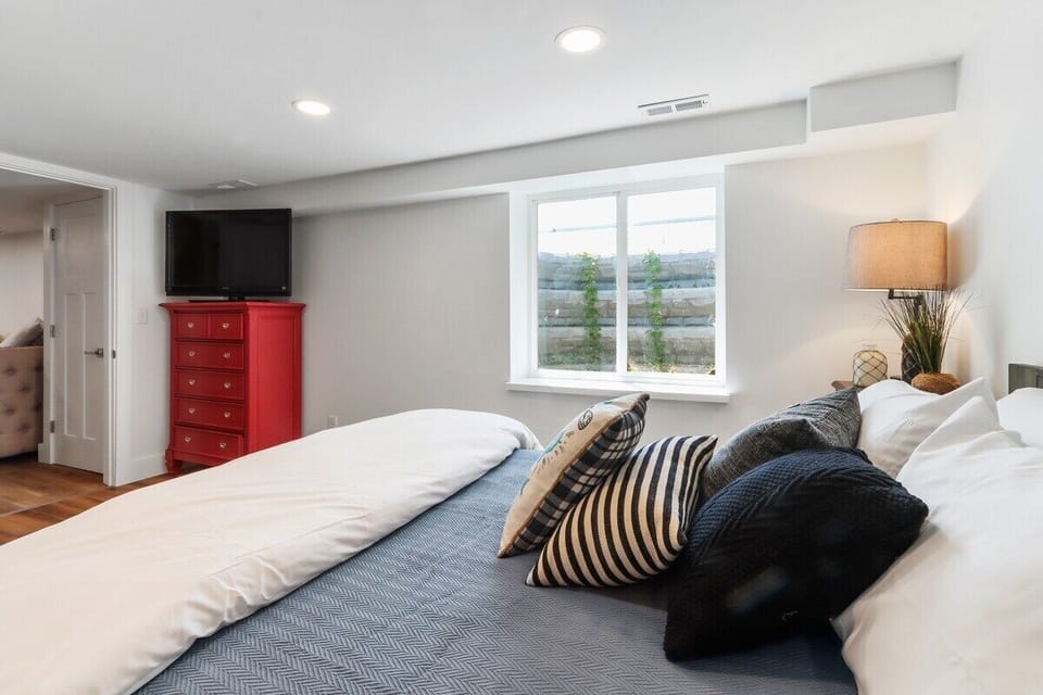 Queen size bed with smart tv, lower level, shared bathroom