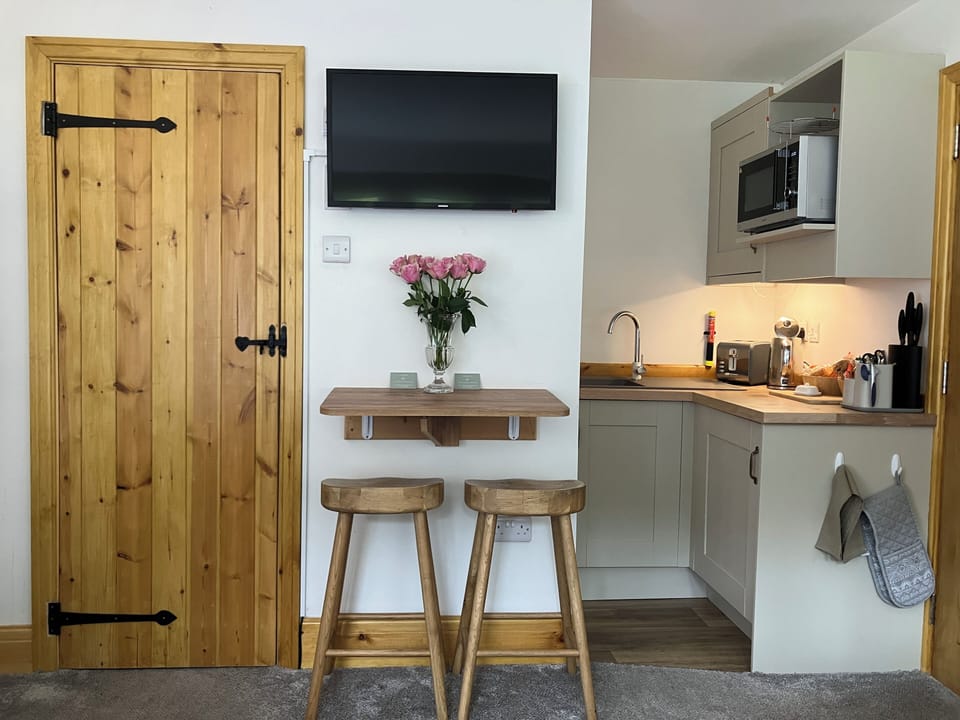 Fold away table top and bar stools. Smart TV with complementary Netflix.