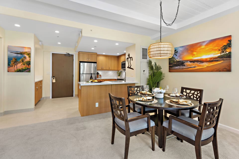 Bright and inviting open-concept kitchen featuring warm wood cabinetry, sleek granite countertops, and a spacious island that flows seamlessly into the living and dining areas. Perfect for entertaining or relaxing in comfort.