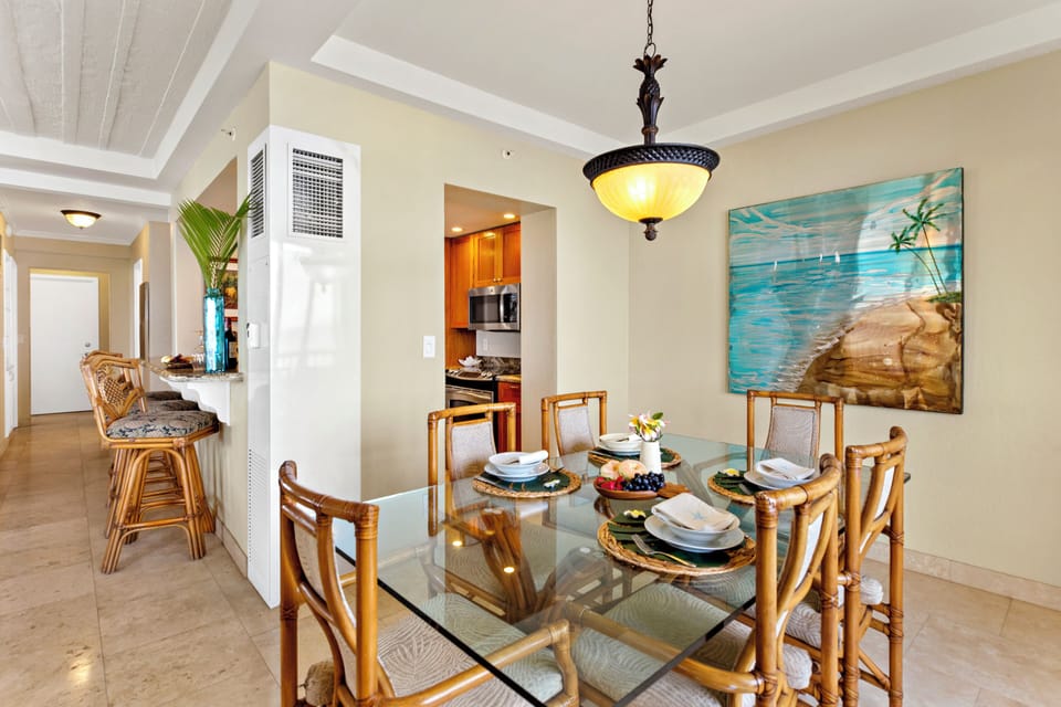 Bright and inviting open-concept kitchen featuring warm wood cabinetry, sleek granite countertops, and a spacious island that flows seamlessly into the living and dining areas. Perfect for entertaining or relaxing in comfort.