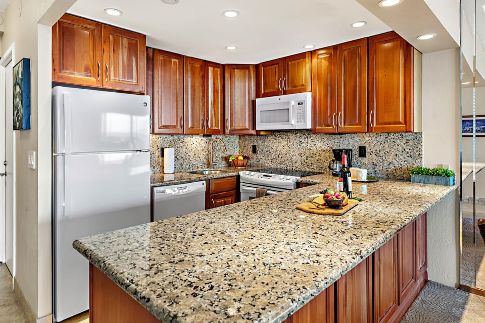 The beautifully updated kitchen features granite countertops, custom wood cabinetry, and modern appliances, offering everything needed for effortless island dining.