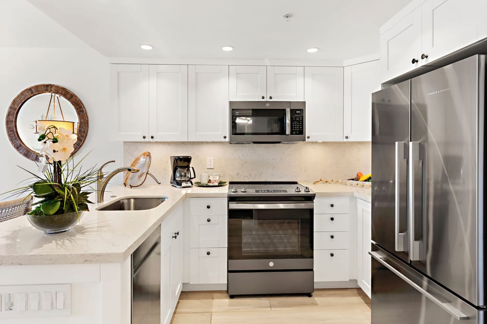 This beautifully updated kitchen combines modern elegance with everyday convenience, featuring sleek finishes, stainless steel appliances, and a bright, airy design perfect for effortless island living.