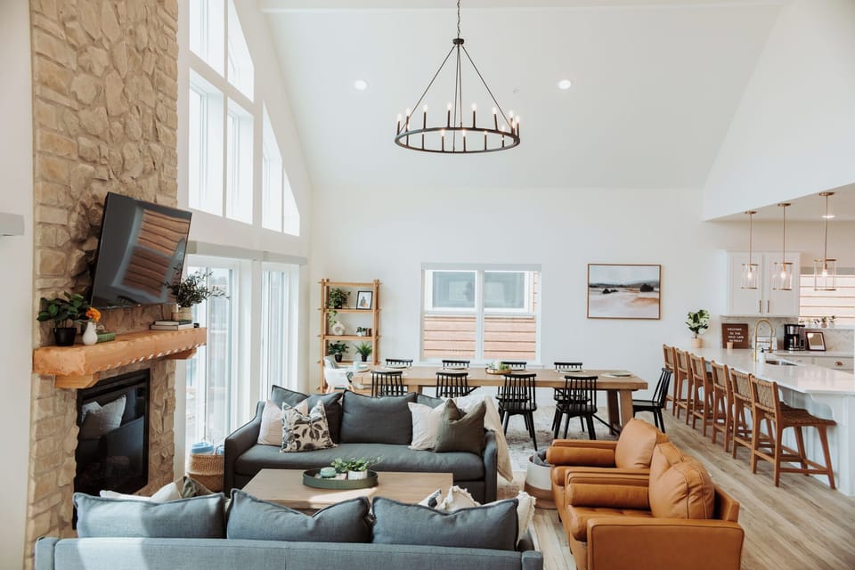 Cozy, spacious main floor living room w/ plenty of seating areas and a fireplace