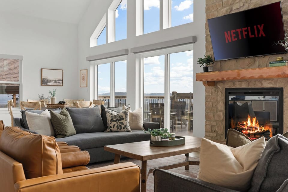 Main floor living room with plenty of cozy seating. Smart TVs in every room.