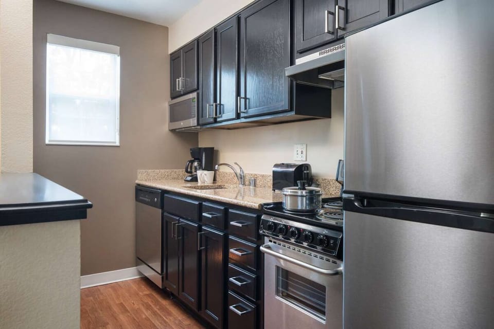 Cook with ease in a full kitchen with stainless appliances.