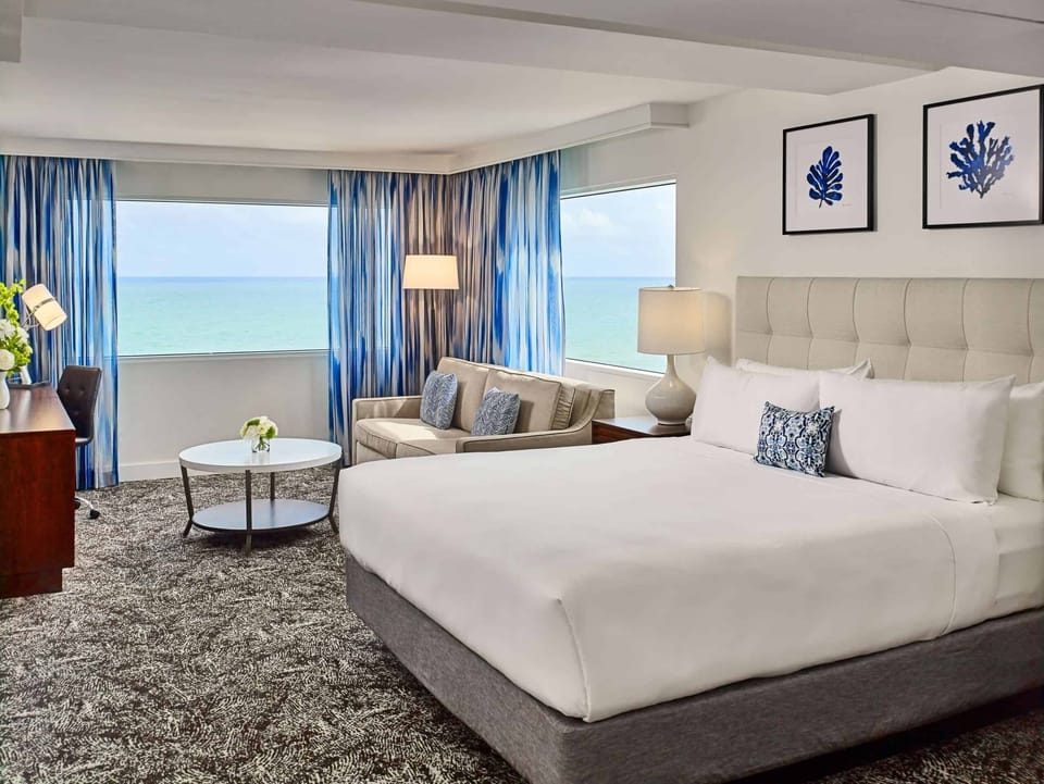 Wake up to panoramic ocean blues from your plush bed.