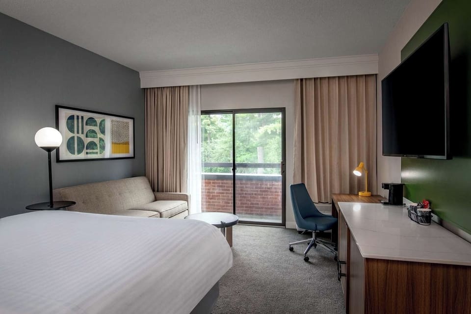 Unwind in a bright room with balcony views and desk.