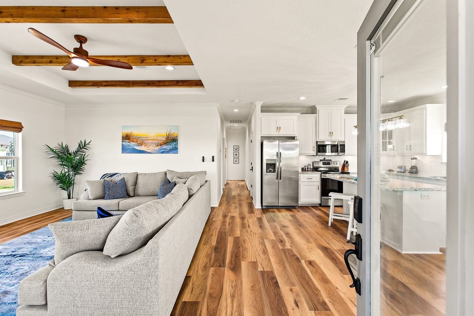 Entryway to the home directly into an open layout living/kitchen area.