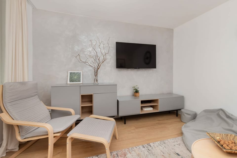 The living room's sleek design is both functional and aesthetically pleasing.