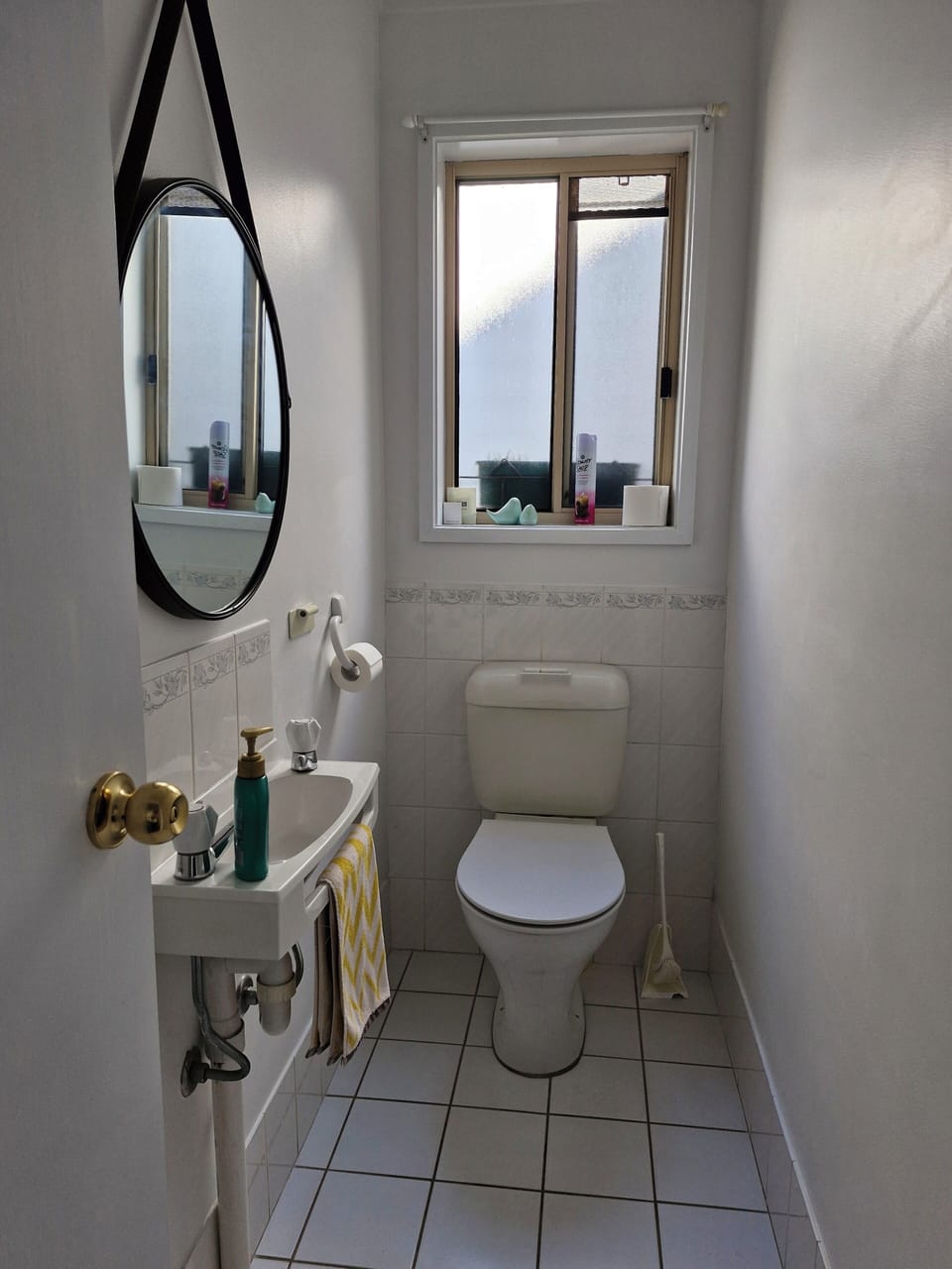 Separate toilet with hand washing sink.
