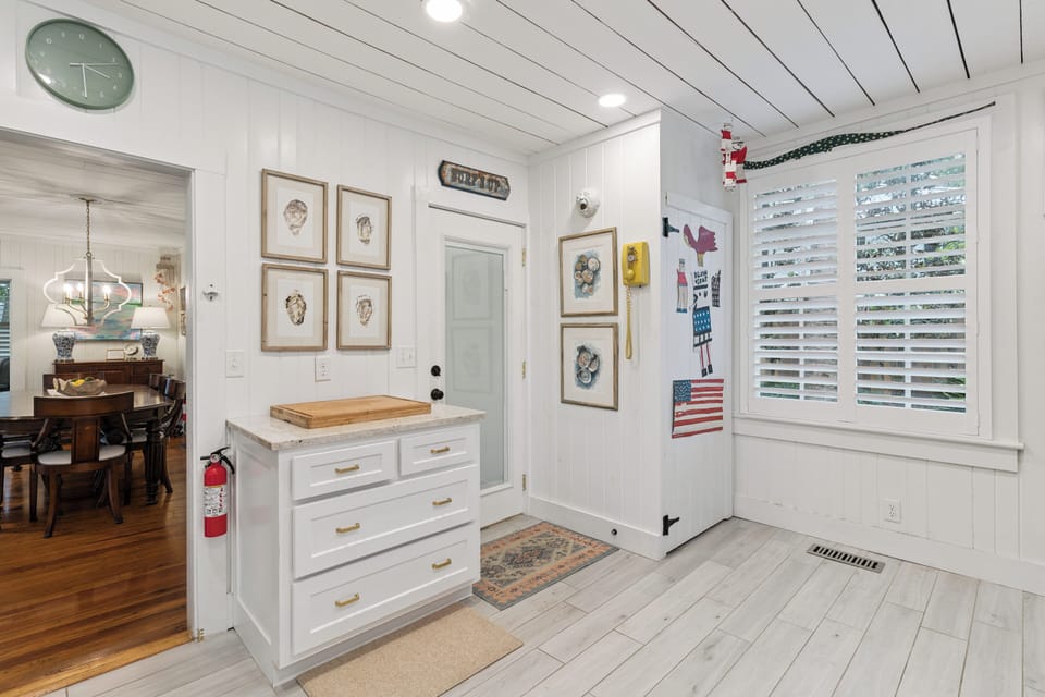 A bright, welcoming entry with nautical charm and coastal decor sets the tone for your seaside escape the moment you step inside.