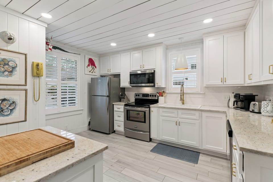 Whip up your favorite meals in this bright, fully-equipped kitchen with stainless appliances, ample counter space, and a cheerful coastal vibe that makes cooking a pleasure.
